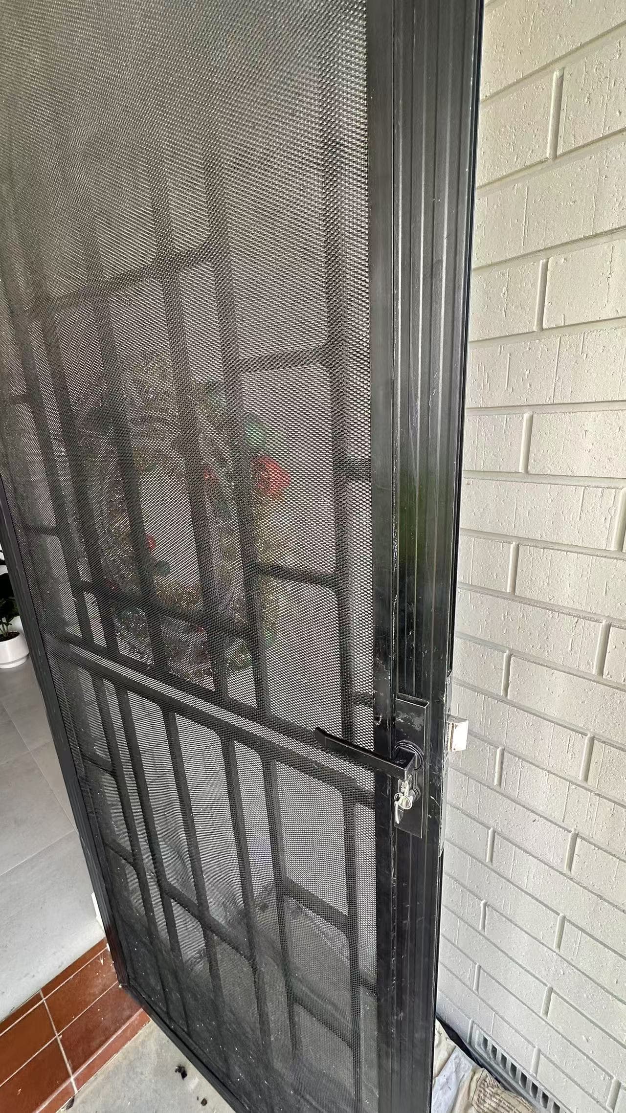 Existing screen-door edge and latch-side frame after the recorded alignment work